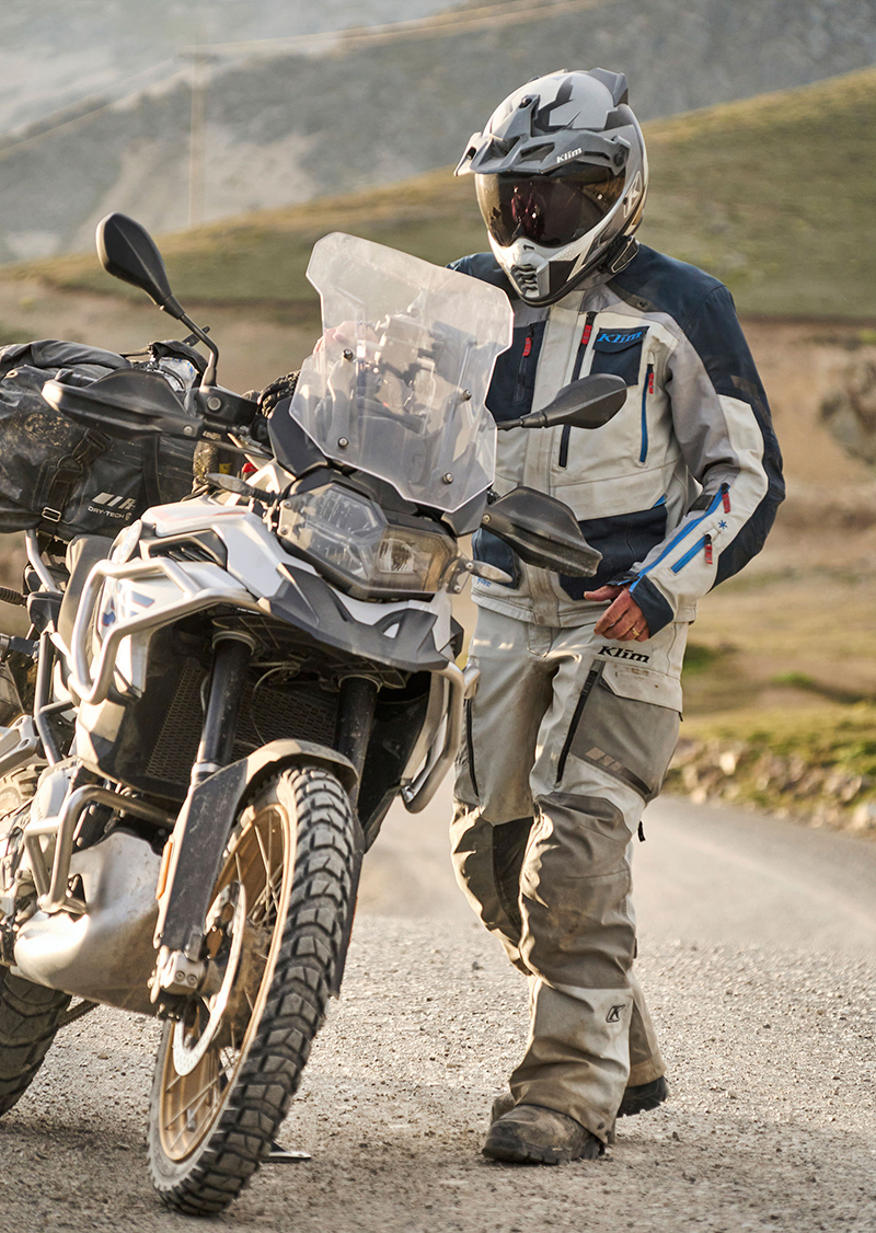 Guy wearing Klim Carlsbad suit next to bike